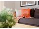 Close-up of a throw pillow on a sofa in a brightly lit living room at 3020 Red Ginger Rd, Kissimmee, FL 34747