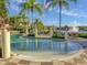 Zero entry pool surrounded by lounge chairs and palm trees at 3020 Red Ginger Rd, Kissimmee, FL 34747