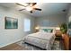 Stylishly decorated bedroom with a large bed, modern art, and a neutral color scheme at 30542 Hoylake St, Sorrento, FL 32776