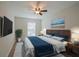 Bedroom featuring wood-look floors, a ceiling fan, window, and a comfortable bed, designed for modern living at 30542 Hoylake St, Sorrento, FL 32776