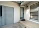 Close-up of a home entrance showcasing a modern door, gray trim, and manicured steps at 30542 Hoylake St, Sorrento, FL 32776