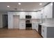 Modern kitchen with white cabinets, stainless steel appliances, and sleek countertops at 30542 Hoylake St, Sorrento, FL 32776