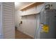 Laundry room with storage shelves and hookups, designed to be a functional and efficient space for household chores at 30542 Hoylake St, Sorrento, FL 32776