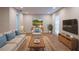Comfortable living room featuring stylish furniture, a large TV, and plenty of natural light at 30542 Hoylake St, Sorrento, FL 32776