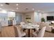 Well-lit living room with a dining table, modern furniture, and a view of the kitchen at 30542 Hoylake St, Sorrento, FL 32776