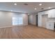Spacious living room featuring wood floors, bright lighting, and built-in cabinets at 30542 Hoylake St, Sorrento, FL 32776