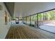 Spacious screened porch with wood floors and serene views, perfect for relaxation and enjoying the outdoors at 30542 Hoylake St, Sorrento, FL 32776