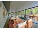 Screened porch featuring wood floors and comfortable seating arrangements, ideal for outdoor relaxation and entertainment at 30542 Hoylake St, Sorrento, FL 32776