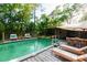 Beautiful backyard in-ground swimming pool with deck, seating, and covered dining area for outdoor gatherings at 30542 Hoylake St, Sorrento, FL 32776