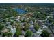 A beautiful home with a lake view, surrounded by trees and other well-maintained properties at 320 Remington Dr, Oviedo, FL 32765