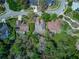 Aerial view of the home showcasing lush landscaping, neighborhood park and the roof at 320 Remington Dr, Oviedo, FL 32765