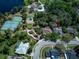 Aerial view of the neighborhood featuring lush greenery, a sparkling lake, and community amenities at 320 Remington Dr, Oviedo, FL 32765