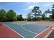 A community basketball court with red, blue, and green surfaces overlooking a tranquil lake setting at 320 Remington Dr, Oviedo, FL 32765