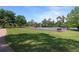 A community basketball and tennis court surrounded by lush green grass and an adjacent playground in a Gathering-friendly community at 320 Remington Dr, Oviedo, FL 32765