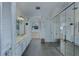 Large bathroom with mirrored closets, ample vanity space, and stylish floral wallpaper at 320 Remington Dr, Oviedo, FL 32765