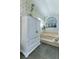 Bathroom featuring a large cabinet and a tub underneath an arched window, complete with tile floors at 320 Remington Dr, Oviedo, FL 32765