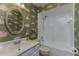 Classic bathroom with wallpaper, white fixtures, and shower at 320 Remington Dr, Oviedo, FL 32765