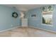 Cozy bedroom with light blue walls, plush carpet, and a window with decorative valance at 320 Remington Dr, Oviedo, FL 32765