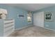 Serene blue bedroom featuring plush carpeting, a window with a valance, and a white bookshelf at 320 Remington Dr, Oviedo, FL 32765