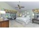 Light and airy bedroom with a ceiling fan, large windows, and a view of the screened lanai at 320 Remington Dr, Oviedo, FL 32765