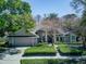 Charming single-story home with mature trees, a well-manicured lawn, and inviting curb appeal at 320 Remington Dr, Oviedo, FL 32765