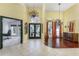 Spacious foyer featuring high ceilings, tile flooring, chandelier, and decorative glass doors at 320 Remington Dr, Oviedo, FL 32765
