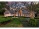Charming home exterior with mature landscaping, a manicured lawn, and a cozy bench at 320 Remington Dr, Oviedo, FL 32765