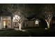Home exterior at night highlighting arched entryway and manicured front lawn at 320 Remington Dr, Oviedo, FL 32765