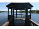 A waterfront gazebo with a wood floor overlooking a serene lake view, perfect for relaxing and enjoying the scenery at 320 Remington Dr, Oviedo, FL 32765
