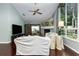 Cozy living room with a fireplace, large windows, and ceiling fan at 320 Remington Dr, Oviedo, FL 32765
