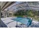 Relaxing screened-in pool area surrounded by lush landscaping, creating a private oasis at 320 Remington Dr, Oviedo, FL 32765
