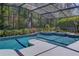 Private screened-in pool featuring a spa and serene views of lush greenery at 320 Remington Dr, Oviedo, FL 32765