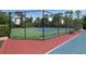 Community tennis court with green and blue surface surrounded by tall fencing at 320 Remington Dr, Oviedo, FL 32765