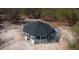 Unique home design featuring a black roof, multiple balconies, and situated on a wooded lot at 32325 State Road 44, Eustis, FL 32736
