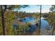 Aerial view of a serene lake surrounded by lush trees and vegetation at 32325 State Road 44, Eustis, FL 32736