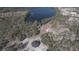 Aerial view of a unique home design with lake and surrounding trees at 32325 State Road 44, Eustis, FL 32736