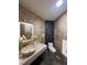 Elegant bathroom featuring an illuminated mirror, stone walls, and a modern vessel sink at 32325 State Road 44, Eustis, FL 32736