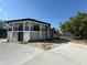 Beautifully designed two-story home with an inviting entrance, balconies, and scenic views of the surrounding nature at 32325 State Road 44, Eustis, FL 32736