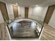 Unique view of the home's entry featuring a glass railing and modern wood accents at 32325 State Road 44, Eustis, FL 32736