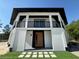 Charming two-story home with a contemporary style, distinctive entry door, and manicured lawn at 32325 State Road 44, Eustis, FL 32736