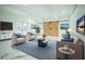 Bright living room featuring comfortable seating, stylish decor, and modern barn door at 32325 State Road 44, Eustis, FL 32736