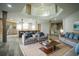 Open-concept living space featuring a kitchen, modern furniture, and staircase to the upper level at 32325 State Road 44, Eustis, FL 32736