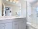 Sleek bathroom with double sinks, modern vanity, and a glass-enclosed shower for a clean and contemporary feel at 330 Rosso Dr, Davenport, FL 33837