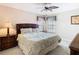 Cozy bedroom with a ceiling fan, two windows, and a comfortable bed with decorative pillows for a relaxing retreat at 330 Rosso Dr, Davenport, FL 33837