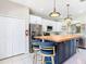 Modern kitchen showcasing a center island with wooden countertop, stainless steel appliances, and white cabinetry at 330 Rosso Dr, Davenport, FL 33837