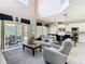 Bright and airy living room flowing into a modern kitchen and patio with a high ceiling for spacious living at 330 Rosso Dr, Davenport, FL 33837