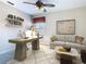 Bright office space with modern desk, shelving, and neutral sofa sitting on top of a shag rug at 330 Rosso Dr, Davenport, FL 33837