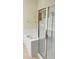 Bathroom featuring a glass-enclosed shower and a soaking tub, offering a bright, luxurious space at 3368 Robert Trent Jones Dr # 40808, Orlando, FL 32835