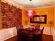 Dining room featuring wood flooring and walls with decorative tapestry and lighting at 3368 Robert Trent Jones Dr # 40808, Orlando, FL 32835