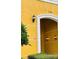 Condo entrance featuring a bright, painted exterior and decorative wall lighting at 3368 Robert Trent Jones Dr # 40808, Orlando, FL 32835